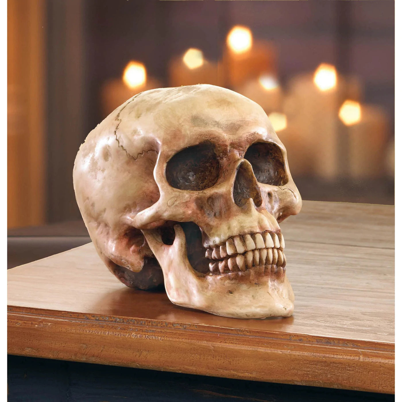 Polyresin Grinning Skull Figure: 6.5 inches by 4.25 inches by 4.6 inches